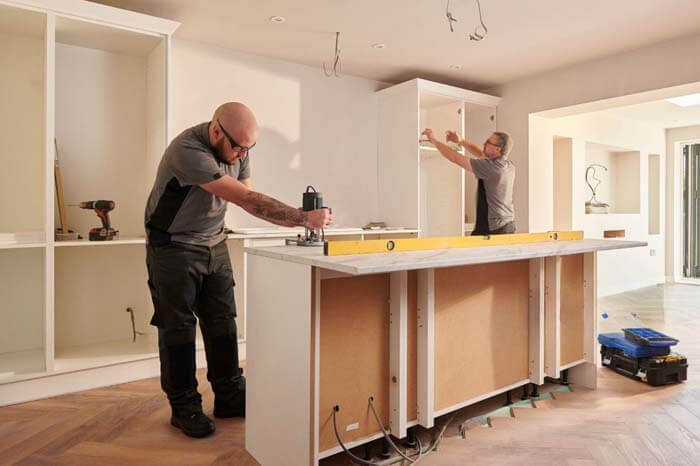 Islington Carpentry & Joinery – skilled carpenters installing kitchen units with precision tools