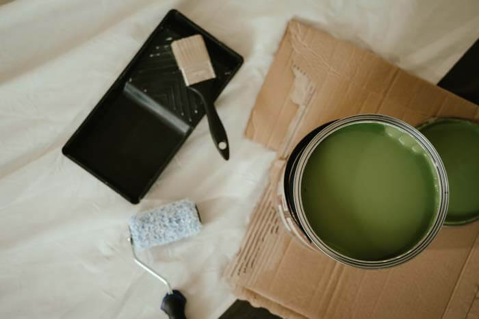 Islington Painting & Decorating – paint roller, brush, and open tin of green paint ready for home interior work